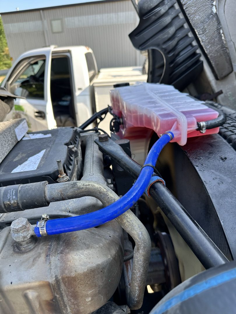 Cooling system service with new blue coolant hose