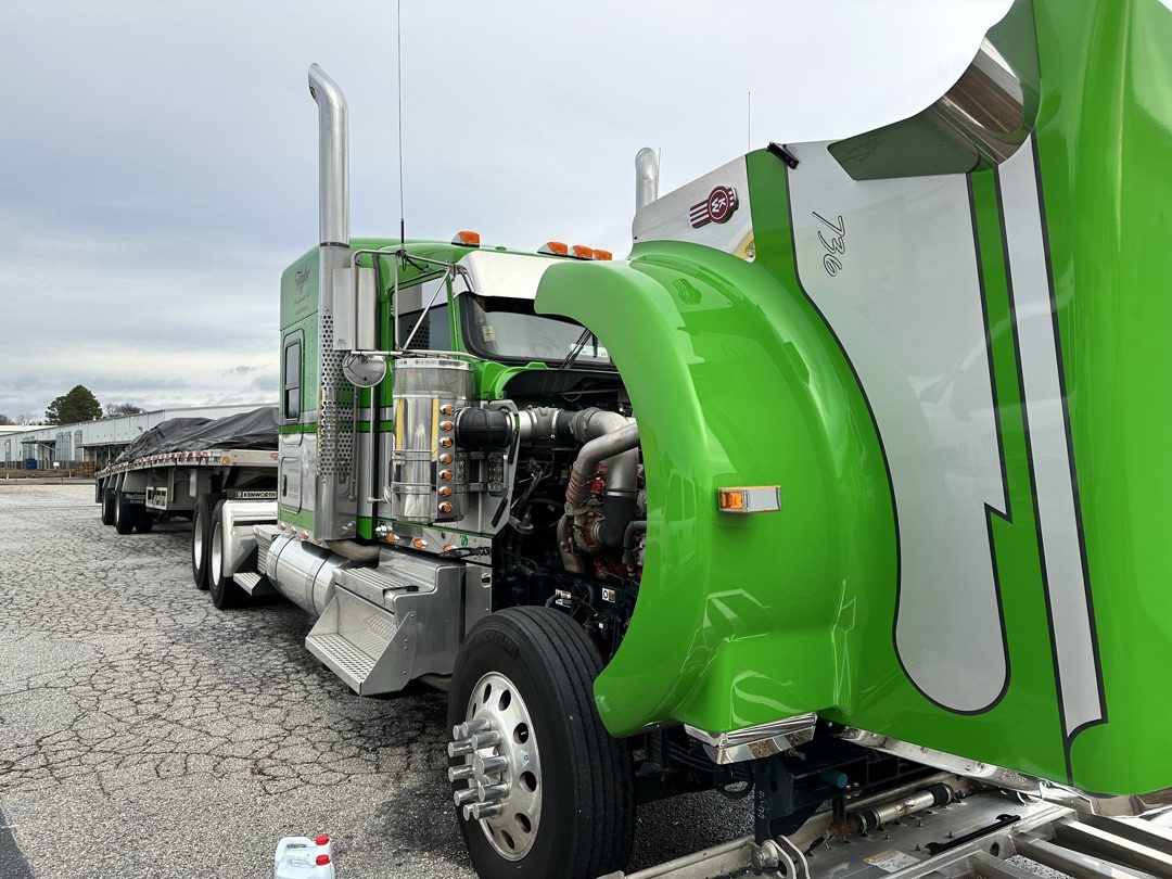 Kenworth W900 with hood up, hi-vis green paint, flatbed trailer