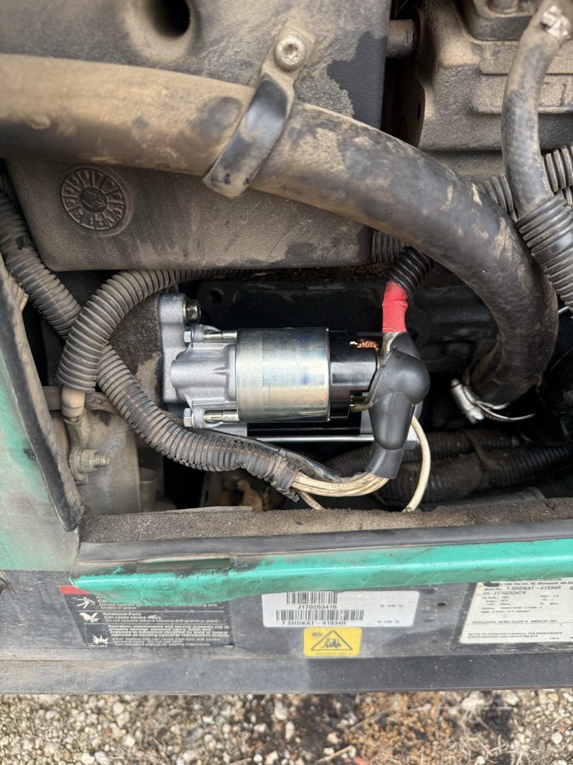 New starter motor installed on a diesel engine